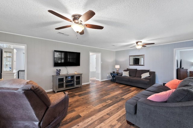 2605 Perry Ln, Alvin, TX 77511 - living room featuring ceiling fan, dark wood-type flooring, ornamental molding, and a textured ceiling