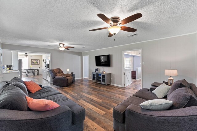 2605 Perry Ln, Alvin, TX 77511 - living room with a ceiling fan, a textured ceiling, and wood finished floors