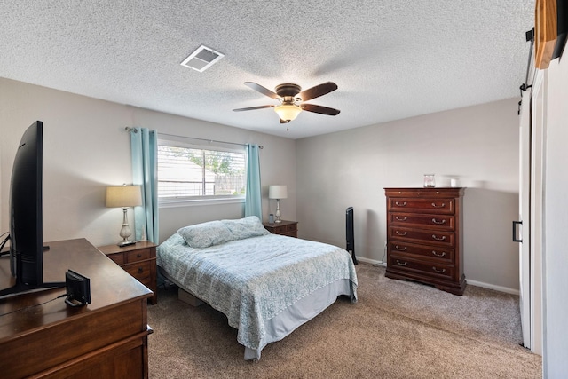 2605 Perry Ln, Alvin, TX 77511 - carpeted bedroom featuring a ceiling fan, a textured ceiling, and a desk
