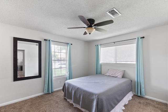 2605 Perry Ln, Alvin, TX 77511 - bedroom featuring carpet flooring, ceiling fan, and a textured ceiling