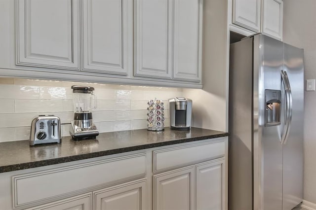 8922 Pinenut Dr, Cypress, TX 77433 - kitchen featuring stainless steel fridge, tasteful backsplash, and dark stone counters