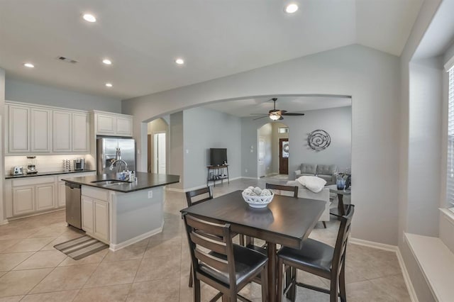 8922 Pinenut Dr, Cypress, TX 77433 - kitchen featuring appliances with stainless steel finishes, arched walkways, a ceiling fan, dark countertops, and recessed lighting