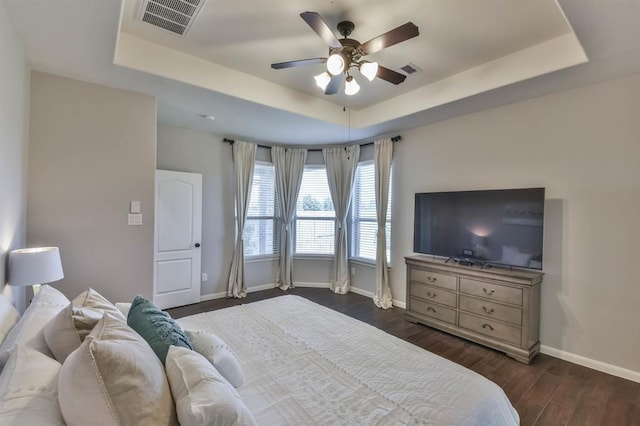 8922 Pinenut Dr, Cypress, TX 77433 - bedroom with a tray ceiling, dark wood finished floors, and a ceiling fan