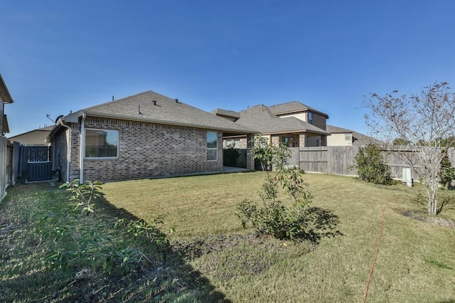 8922 Pinenut Dr, Cypress, TX 77433 - back of property with a fenced backyard, brick siding, and roof with shingles