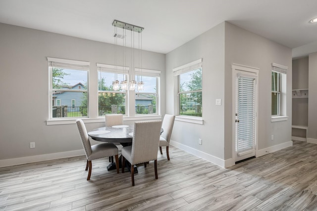 16726 Echo Heights Dr, Cypress, TX 77433 - dining area with wood finished floors, a chandelier, and plenty of natural light