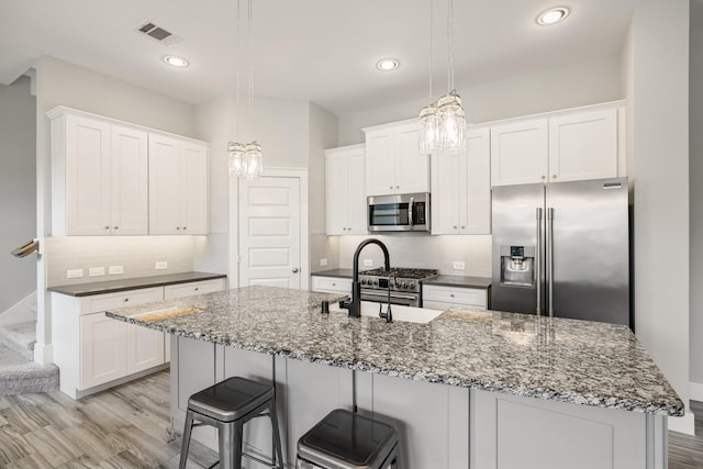 16726 Echo Heights Dr, Cypress, TX 77433 - kitchen featuring stainless steel appliances, light wood-type flooring, white cabinets, and recessed lighting