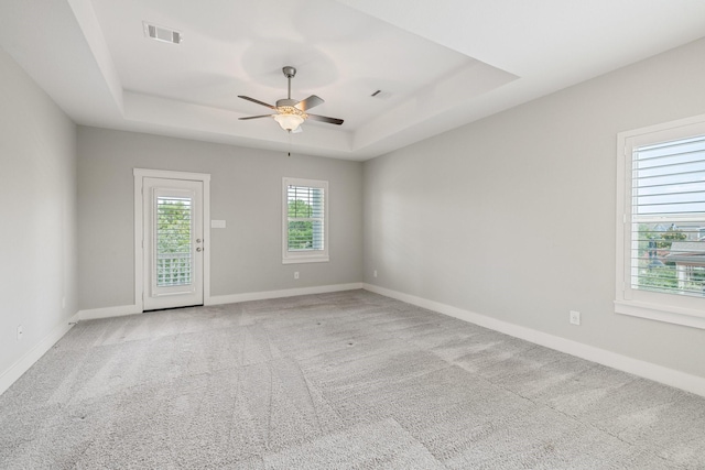 16726 Echo Heights Dr, Cypress, TX 77433 - unfurnished room featuring a tray ceiling, light carpet, and a ceiling fan