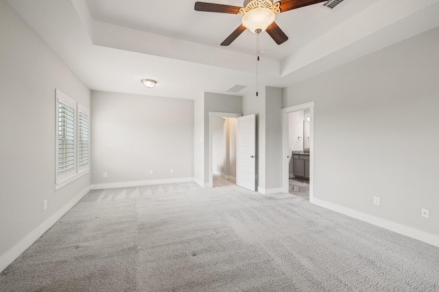 16726 Echo Heights Dr, Cypress, TX 77433 - unfurnished bedroom featuring light carpet, a raised ceiling, and ensuite bathroom