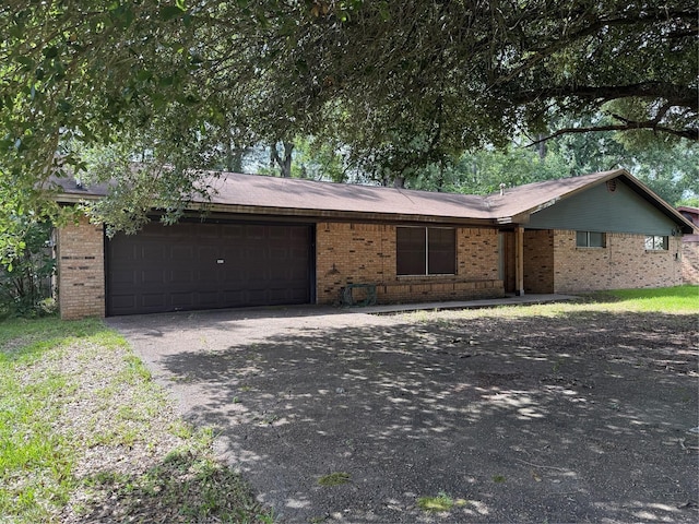 200 Cunningham Dr, Lufkin, TX 75901 - ranch-style house featuring driveway, brick siding, and an attached garage