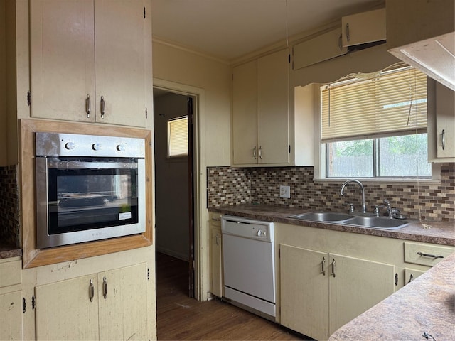 200 Cunningham Dr, Lufkin, TX 75901 - kitchen featuring dishwasher, oven, dark wood-style flooring, decorative backsplash, and ornamental molding