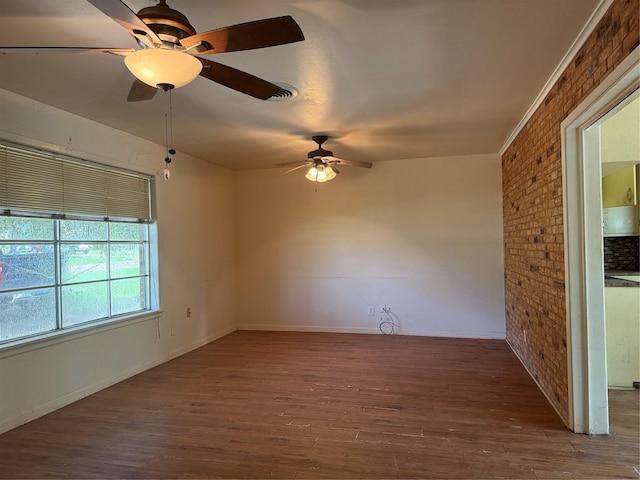 200 Cunningham Dr, Lufkin, TX 75901 - unfurnished room with ceiling fan, wood finished floors, and brick wall