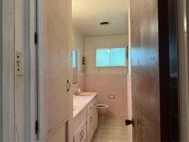 200 Cunningham Dr, Lufkin, TX 75901 - bathroom with vanity, tile walls, and wainscoting