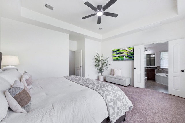 23706 Tristan Bay Ct, Spring, TX 77386 - bedroom with a raised ceiling, carpet, connected bathroom, and a ceiling fan
