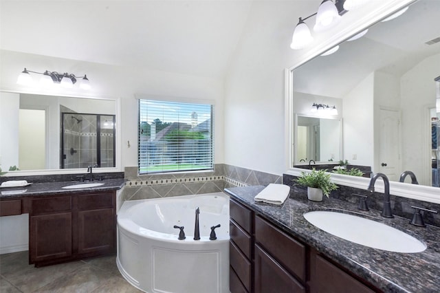 23706 Tristan Bay Ct, Spring, TX 77386 - bathroom featuring lofted ceiling, a stall shower, a jetted tub, tile patterned flooring, and two vanities