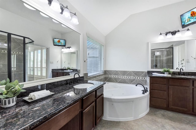23706 Tristan Bay Ct, Spring, TX 77386 - full bath featuring a shower stall, lofted ceiling, a jetted tub, tile patterned floors, and two vanities