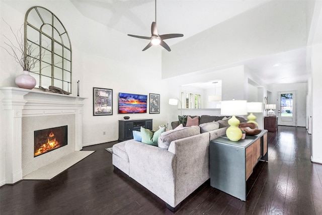 23706 Tristan Bay Ct, Spring, TX 77386 - living room with dark wood-style floors, ceiling fan, a premium fireplace, and a high ceiling