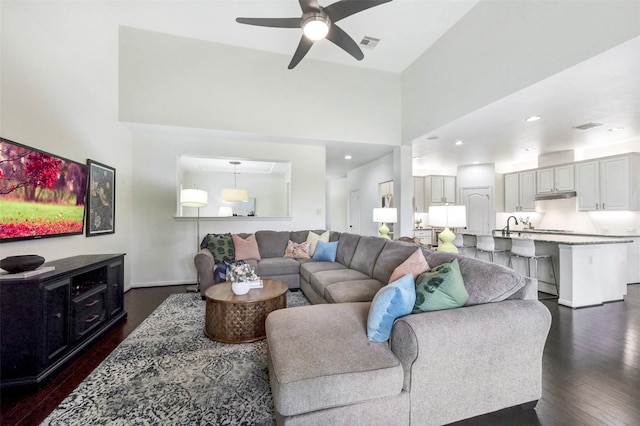 23706 Tristan Bay Ct, Spring, TX 77386 - living area with dark wood-type flooring, ceiling fan, and a towering ceiling