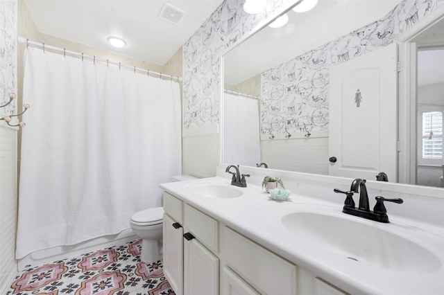 23706 Tristan Bay Ct, Spring, TX 77386 - full bathroom with wallpapered walls, double vanity, shower / bath combo with shower curtain, tile walls, and tile patterned floors