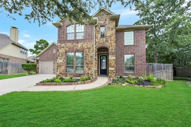 23706 Tristan Bay Ct, Spring, TX 77386 - traditional home featuring stone siding, concrete driveway, brick siding, and an attached garage