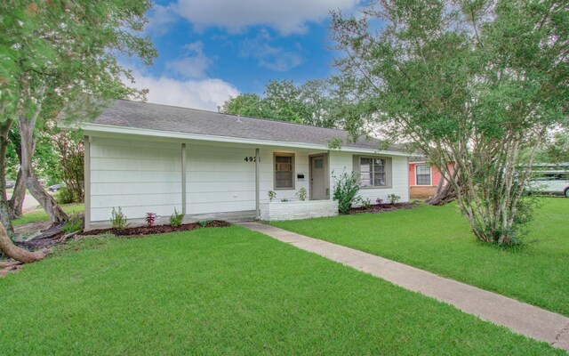 4921 Michael Dr, Houston, TX 77017 - ranch-style house featuring a front yard and roof with shingles
