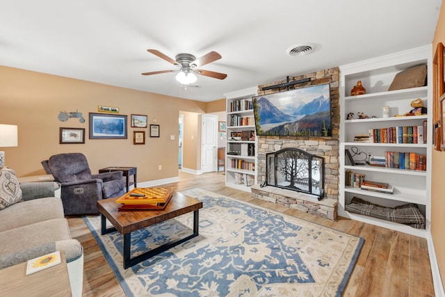 3211 County Road 237, Alvin, TX 77511 - living area with ceiling fan, a fireplace, and wood finished floors