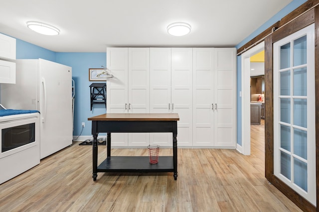3211 County Road 237, Alvin, TX 77511 - kitchen with range, light wood finished floors, freestanding refrigerator, and white cabinets