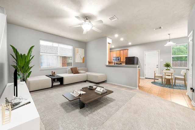 15515 Hinsdale Springs Ln, Houston, TX 77053 - living room with healthy amount of natural light, ceiling fan, light colored carpet, light tile patterned floors, and recessed lighting