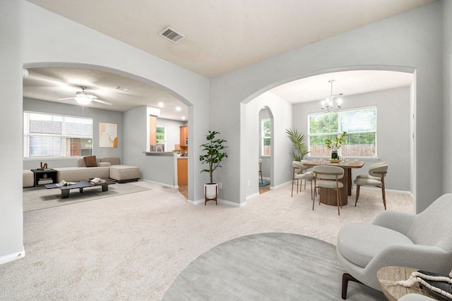 15515 Hinsdale Springs Ln, Houston, TX 77053 - carpeted living area featuring arched walkways, a ceiling fan, and a chandelier