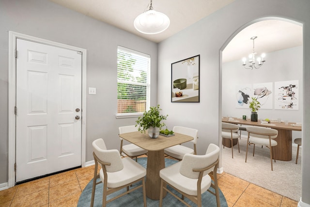 15515 Hinsdale Springs Ln, Houston, TX 77053 - dining area featuring arched walkways, light tile patterned floors, and a chandelier