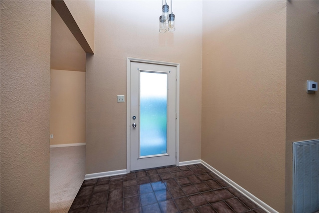 15111 Silverman St, Houston, TX 77598 - doorway to outside with a textured wall and dark tile patterned floors