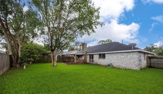 15111 Silverman St, Houston, TX 77598 - rear view of property featuring a fenced backyard, a chimney, brick siding, and roof with shingles