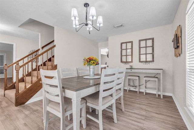 3302 Candlelon Dr, Spring, TX 77388 - dining area featuring light wood-style floors, stairway, and a chandelier