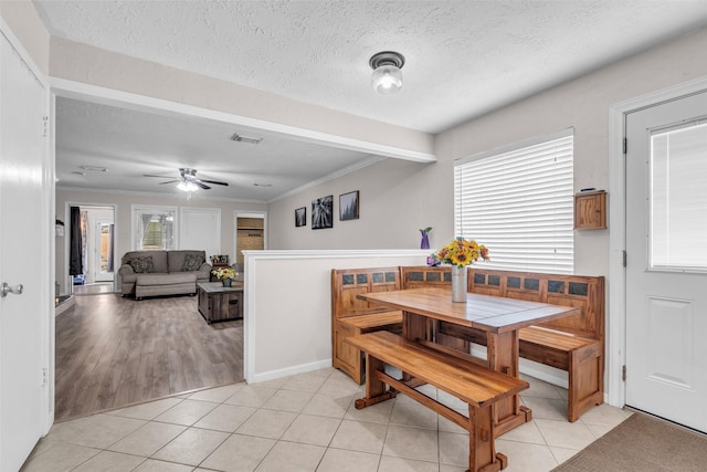 3302 Candlelon Dr, Spring, TX 77388 - dining room with light tile patterned floors, a textured ceiling, ceiling fan, and crown molding