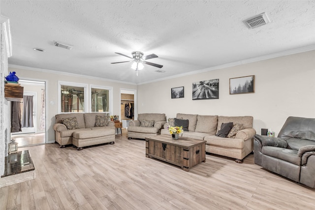 3302 Candlelon Dr, Spring, TX 77388 - living room featuring a ceiling fan, a textured ceiling, light wood-type flooring, and crown molding