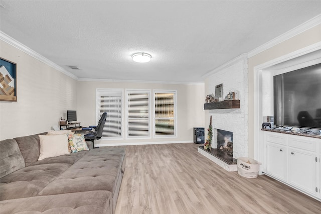 3302 Candlelon Dr, Spring, TX 77388 - living area with light wood-style floors, ornamental molding, a fireplace, a desk, and a textured ceiling