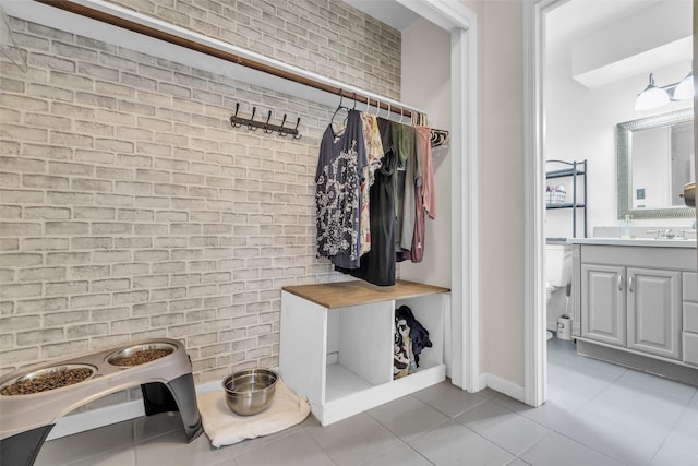 3302 Candlelon Dr, Spring, TX 77388 - mudroom with light tile patterned flooring and brick wall