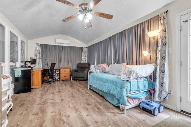 3302 Candlelon Dr, Spring, TX 77388 - bedroom featuring an AC wall unit, lofted ceiling, light wood-style flooring, an office area, and a textured ceiling