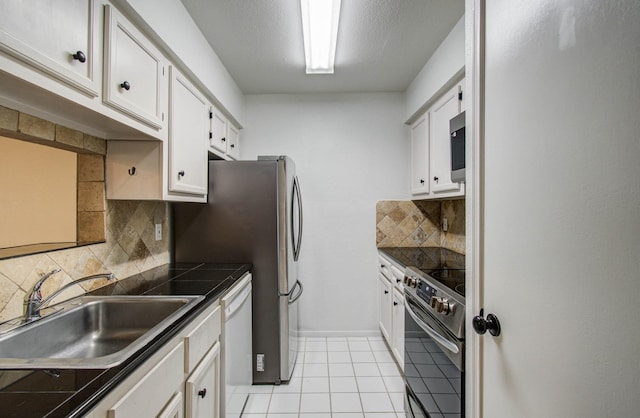 5711 Sugar Hill Dr Unit 108, Houston, TX 77057 - kitchen featuring stainless steel appliances, white cabinets, backsplash, and light tile patterned floors