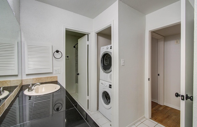 5711 Sugar Hill Dr Unit 108, Houston, TX 77057 - laundry area featuring stacked washer / dryer