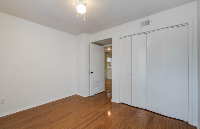 5711 Sugar Hill Dr Unit 108, Houston, TX 77057 - unfurnished bedroom with wood finished floors, a closet, and a ceiling fan