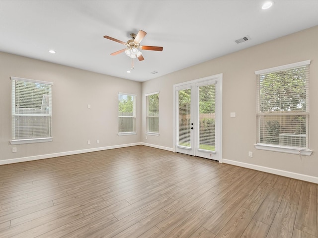 1109 Robbie St, Houston, TX 77009 - empty room with french doors, ceiling fan, healthy amount of natural light, wood finished floors, and recessed lighting