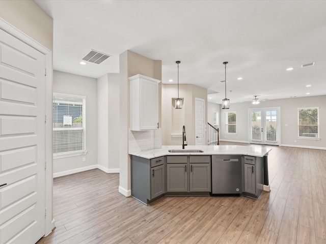 1109 Robbie St, Houston, TX 77009 - kitchen with dishwasher, gray cabinetry, light wood-type flooring, ceiling fan, and open floor plan