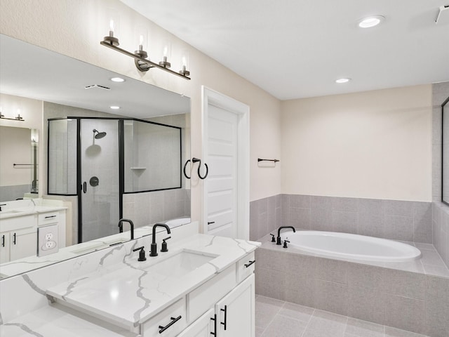 1109 Robbie St, Houston, TX 77009 - bathroom with a garden tub, a shower stall, two vanities, recessed lighting, and tile patterned floors