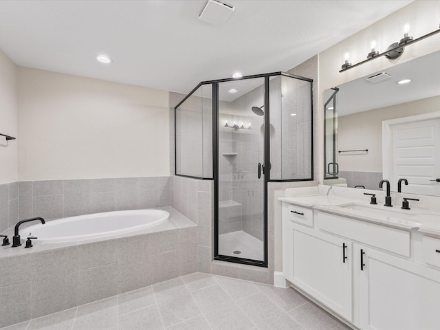 1109 Robbie St, Houston, TX 77009 - bathroom with vanity, a garden tub, a stall shower, tile patterned flooring, and recessed lighting