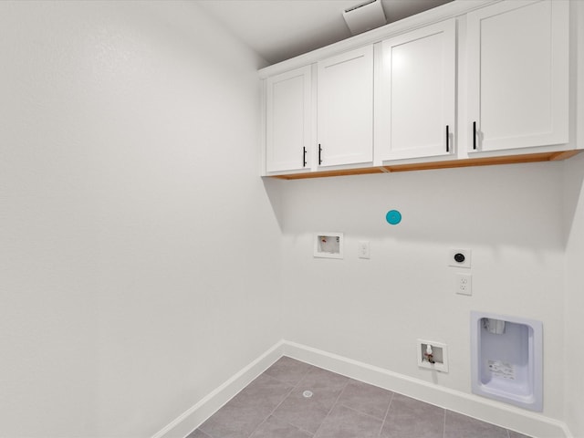 1109 Robbie St, Houston, TX 77009 - washroom featuring cabinet space, hookup for an electric dryer, washer hookup, gas dryer hookup, and light tile patterned flooring