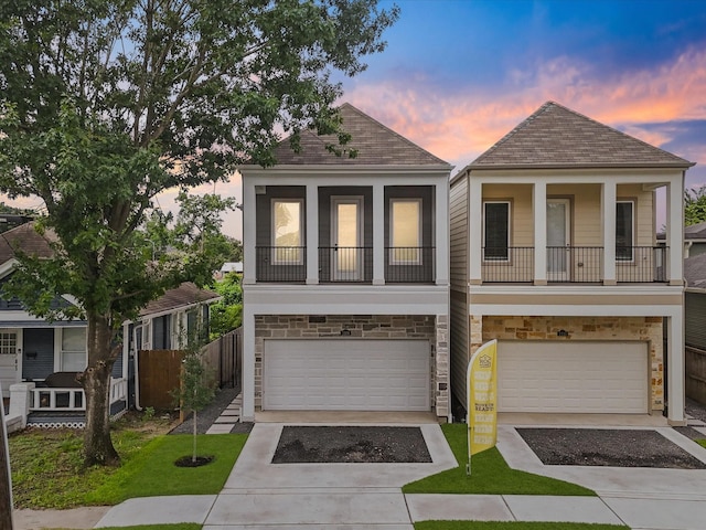 1109 Robbie St, Houston, TX 77009 - view of front facade with stone siding, driveway, a garage, and a shingled roof