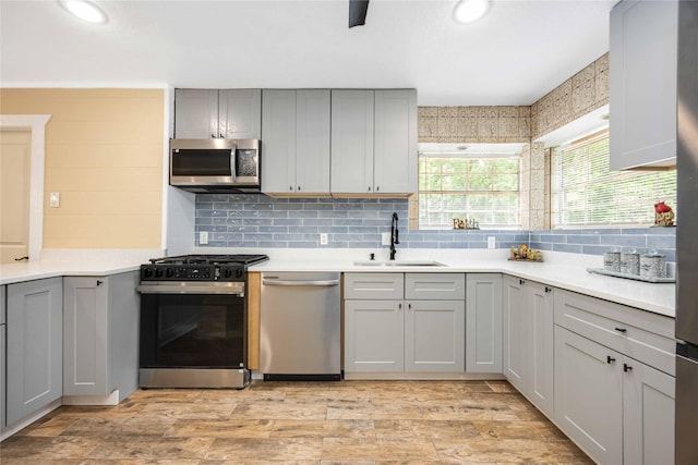478 Brandon Rd, Conroe, TX 77302 - kitchen with stainless steel appliances, gray cabinets, backsplash, light countertops, and recessed lighting