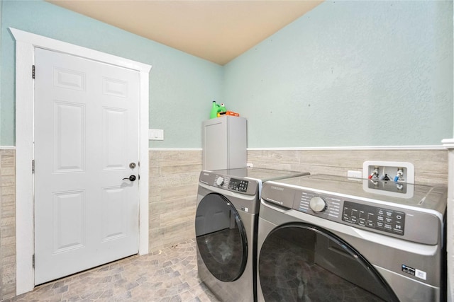 478 Brandon Rd, Conroe, TX 77302 - washroom with washing machine and clothes dryer, tile walls, and wainscoting