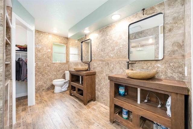 478 Brandon Rd, Conroe, TX 77302 - full bath featuring a walk in closet, wood finished floors, vanity, tile walls, and a shower