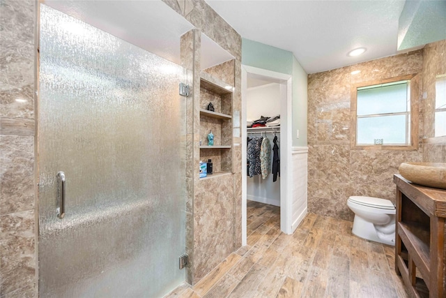 478 Brandon Rd, Conroe, TX 77302 - bathroom with a stall shower, wood finished floors, a spacious closet, built in features, and vanity